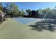 Well-maintained community tennis courts surrounded by mature trees, offering a great amenity for residents at 4415 Dorset Ln, Suwanee, GA 30024