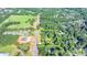 The view shows the large lot has lush green trees surrounded by a neighborhood at 5690 Abbotts Bridge Rd, Johns Creek, GA 30097