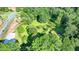 Picturesque lot with mature trees and partially cleared area, ready for development in a prime location at 5690 Abbotts Bridge Rd, Johns Creek, GA 30097
