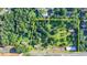 Aerial shot showcases a large lot with trees, houses, and road access at 5690 Abbotts Bridge Rd, Johns Creek, GA 30097