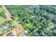 Aerial view displays a large lot for sale near a road in a wooded area at 5690 Abbotts Bridge Rd, Johns Creek, GA 30097