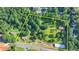 Aerial shot showcasing a large lot with trees, houses, and road access at 5690 Abbotts Bridge Rd, Johns Creek, GA 30097