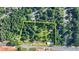 A scenic aerial view showcases the potential development site with mature trees at 5690 Abbotts Bridge Rd, Johns Creek, GA 30097
