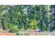 The aerial view of the tree-lined lot surrounded by a community and main road at 5690 Abbotts Bridge Rd, Johns Creek, GA 30097