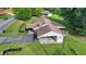 An aerial view shows the home's driveway, side carport, and chimneys amidst the green landscape at 5690 Abbotts Bridge Rd, Johns Creek, GA 30097