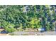An aerial shot showing the lot in a tree filled neighborhood, near a main road at 5690 Abbotts Bridge Rd, Johns Creek, GA 30097