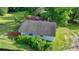 This aerial shot displays the roof and exterior features of the house, surrounded by lush greenery at 5690 Abbotts Bridge Rd, Johns Creek, GA 30097