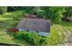 This aerial shot displays the roof and exterior features of the house, surrounded by lush greenery at 5690 Abbotts Bridge Rd, Johns Creek, GA 30097