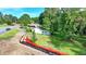 An aerial view showcases the property's location near the road with ample surrounding greenery at 5690 Abbotts Bridge Rd, Johns Creek, GA 30097