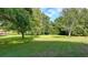A large backyard with mature trees provides ample outdoor space and privacy at 5690 Abbotts Bridge Rd, Johns Creek, GA 30097