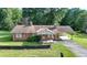 Charming brick home with mature trees and a spacious front yard at 5690 Abbotts Bridge Rd, Johns Creek, GA 30097