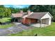 The home features a brick exterior, a side carport, and a well-maintained lawn at 5690 Abbotts Bridge Rd, Johns Creek, GA 30097