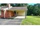 Exterior view of the side carport and brick detailing enhancing the architectural appeal of the house at 5690 Abbotts Bridge Rd, Johns Creek, GA 30097