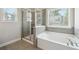 Bright bathroom featuring a separate shower and soaking tub with natural light at 787 Belrose Dr, Smyrna, GA 30080
