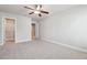 Bedroom featuring neutral carpet, ceiling fan and open door to a walk-in closet at 787 Belrose Dr, Smyrna, GA 30080