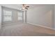 Spacious bedroom with neutral carpet, ceiling fan and natural light from two windows at 787 Belrose Dr, Smyrna, GA 30080