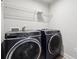 Laundry room featuring front load washer and dryer and wire shelf at 787 Belrose Dr, Smyrna, GA 30080