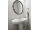Powder room featuring a pedestal sink, mirror and towel ring at 787 Belrose Dr, Smyrna, GA 30080