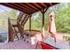 Inviting back deck featuring an umbrella-covered table, grill, and wooded view at 5093 Heartland Trl, Hoschton, GA 30548