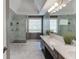 Modern bathroom featuring double sinks, large mirrors, bright lighting, and a walk-in glass shower at 5093 Heartland Trl, Hoschton, GA 30548