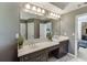 Elegant bathroom featuring double vanities and access to a connected living room area at 5093 Heartland Trl, Hoschton, GA 30548