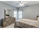 Cozy bedroom featuring a dresser with mirror, ample natural light, and neutral decor at 5093 Heartland Trl, Hoschton, GA 30548