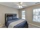 Bedroom with large windows, ceiling fan, and neutral carpet at 5093 Heartland Trl, Hoschton, GA 30548