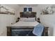 A cozy bedroom with decorative art pieces and a plush bed with decorative details, creating a tranquil retreat at 5093 Heartland Trl, Hoschton, GA 30548