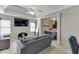 Comfortable living room area with large TV, plush seating, neutral colors, and access to additional bedroom space at 5093 Heartland Trl, Hoschton, GA 30548
