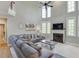 Open concept living room with tall ceilings, a cozy fireplace, and lots of natural light at 5093 Heartland Trl, Hoschton, GA 30548