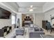 Spacious area with TV and bedroom area with comfortable seating and a workspace, all with stylish design and comfort at 5093 Heartland Trl, Hoschton, GA 30548