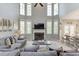 Inviting living room features a fireplace, large windows, and comfortable seating area at 5093 Heartland Trl, Hoschton, GA 30548