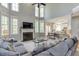 Spacious living room with fireplace, soaring windows, and an open floor plan to the kitchen at 5093 Heartland Trl, Hoschton, GA 30548