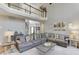 Bright living room featuring high ceilings, stylish decor, and views of the upper floor balcony at 5093 Heartland Trl, Hoschton, GA 30548