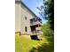 Two-story wooden deck overlooking a grassy backyard with wooded area beyond at 4346 Traipse Path, Ellenwood, GA 30294