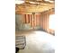 Unfinished basement with concrete foundation, wood framing and bright window at 4346 Traipse Path, Ellenwood, GA 30294