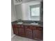 Bathroom vanity features double sinks, granite countertops, and dark wood cabinets at 4346 Traipse Path, Ellenwood, GA 30294