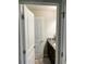 A bathroom entrance showcases dark cabinets, granite counters, and a well-lit vanity at 4346 Traipse Path, Ellenwood, GA 30294