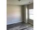 Cozy bedroom featuring wood-look floors and a bright window for natural light at 4346 Traipse Path, Ellenwood, GA 30294