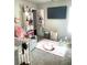 Comfortable Bedroom with a rocking chair, crib, play gym, and storage at 4346 Traipse Path, Ellenwood, GA 30294