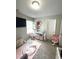 Bright Bedroom with a play area, crib, changing table, and storage shelves at 4346 Traipse Path, Ellenwood, GA 30294