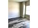 Bright bedroom featuring wood-look floors and a bright window for natural light at 4346 Traipse Path, Ellenwood, GA 30294