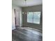 Dining area with modern chandelier and large window, complemented by wood-look flooring at 4346 Traipse Path, Ellenwood, GA 30294