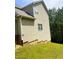 Side view of a light-colored house with vinyl siding and green grass at 4346 Traipse Path, Ellenwood, GA 30294