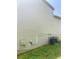 Side view of a light-colored house with vinyl siding and exterior utility features at 4346 Traipse Path, Ellenwood, GA 30294