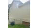 Close up view of a light-colored house's vinyl siding and air conditioning unit in the back yard at 4346 Traipse Path, Ellenwood, GA 30294