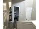 Upper-level hallway with a view of the downstairs area, neutral colors, and wood-look floors at 4346 Traipse Path, Ellenwood, GA 30294