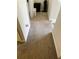A carpeted hallway features neutral walls and trim, leading to other areas of the home at 4346 Traipse Path, Ellenwood, GA 30294