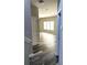 Inviting hallway with wood-look flooring, leading into a sunlit living area at 4346 Traipse Path, Ellenwood, GA 30294