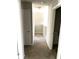 Hallway features neutral carpet and paint leading to upstairs area and doorway to the right at 4346 Traipse Path, Ellenwood, GA 30294